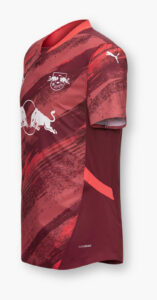 0K1u5WgZKuESSHi | UAE SPORT STORE Red maroon football jersey with bold brushstroke pattern, RB Leipzig crest on the chest, white Puma logo on the sleeve, and 'ULTRAWEAVE' text near the hem.