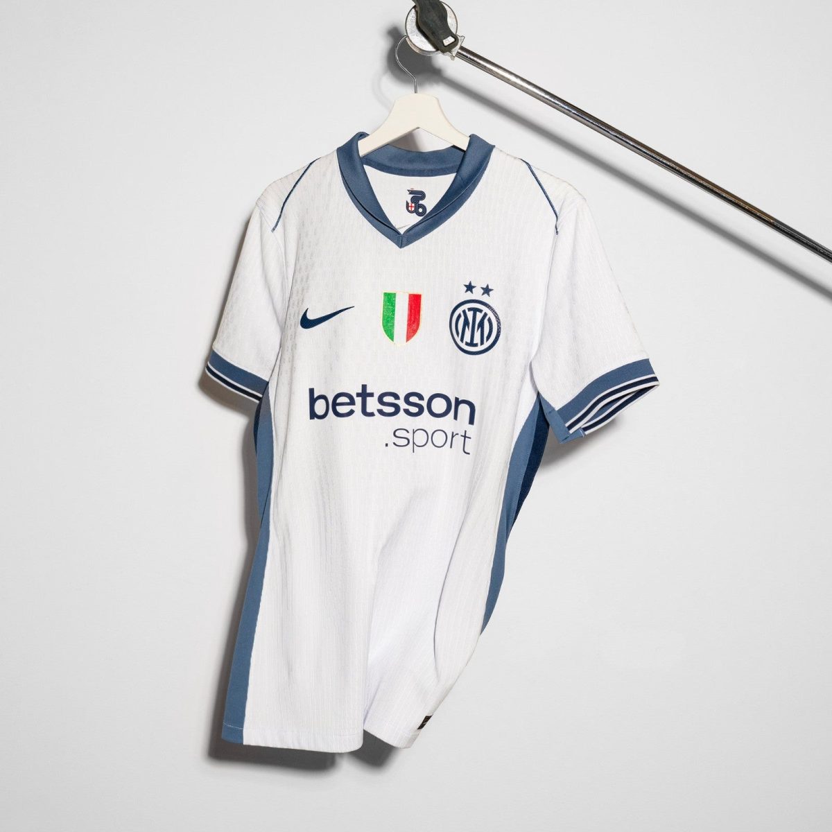 White Inter Milan football jersey on a hanger with blue trim, Nike logo, crest, and Betsson Sport sponsor visible.