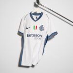 White Inter Milan football jersey on a hanger with blue trim, Nike logo, crest, and Betsson Sport sponsor visible.