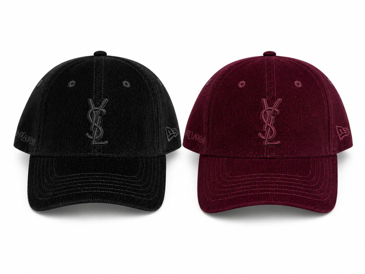 Pair of black and burgundy corduroy baseball caps with the YSL monogram on the front and branding on the sides.