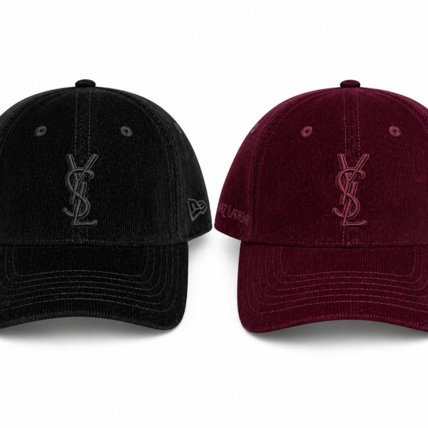 Pair of black and burgundy corduroy baseball caps with the YSL monogram on the front and branding on the sides.