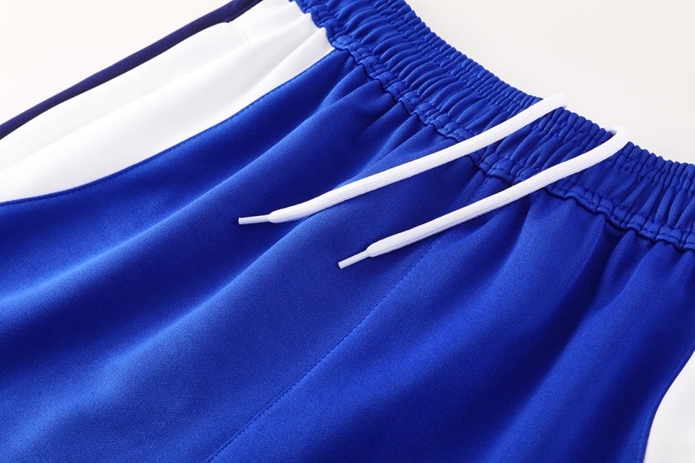 0afe6faa | UAE SPORT STORE Blue athletic shorts with a white drawstring and elastic waistband, close-up detail.