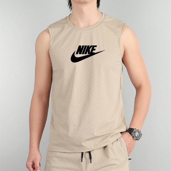 Tan sleeveless ribbed Nike tank top on a person, with the black Nike swoosh on the chest Vector is centered here.