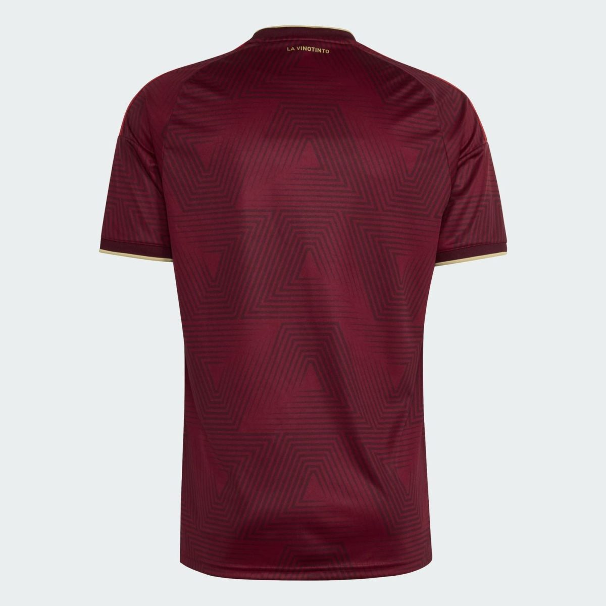 Back view of a maroon soccer jersey with geometric pattern and gold collar trim, small 'LA VINOTINTO' text at neck.