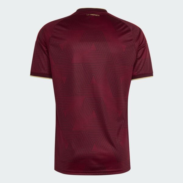 Back view of a maroon soccer jersey with geometric pattern and gold collar trim, small 'LA VINOTINTO' text at neck.