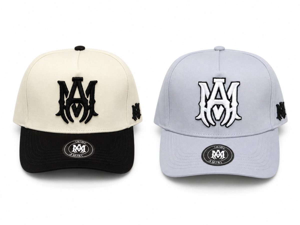 Two baseball caps displayed side by side: a beige crown with a black brim on the left and a light blue crown with a matching brim on the right, each with a bold M logo on the front and an M on the side panel.
