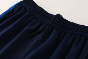 0d588d2a | UAE SPORT STORE Close-up of a navy blue elastic waistband with a black drawstring on athletic shorts/pants edge.