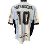 Back view of a light blue and cream striped soccer jersey with 'MARADONA' and the number 10 on the back.