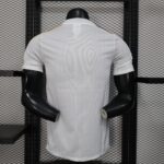 0deafdb9 | UAE SPORT STORE Back view of a white pinstriped shirt on a black mannequin torso against a metal grid shelving background.
