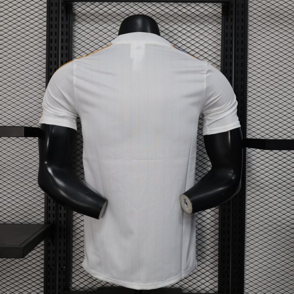 Back view of a white pinstriped shirt on a black mannequin torso against a metal grid shelving background.
