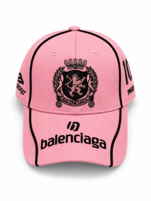 Neon pink Balenciaga cap with crest logo and black accents, stylish streetwear accessory.
