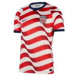 Front view of a USA soccer jersey with bold red and white wavy stripes, navy collar, and team crest on the chest.