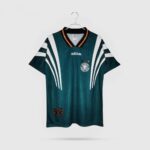 Adidas Germany national team soccer jersey on a hanger, teal with white stripe details and crest above the heart.