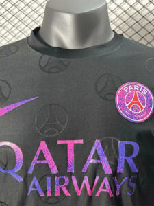 Black Paris Saint-Germain football jersey on a display bust, with a purple-pink Qatar Airways sponsor across the chest and the PSG badge on the left.
