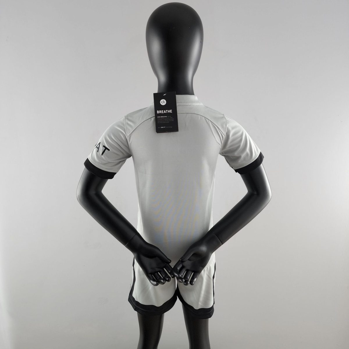 Back view of a black mannequin wearing a light gray athletic shirt; neck tag reads 'BREATHE' with a small circular logo.