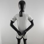 Back view of a black mannequin wearing a light gray athletic shirt; neck tag reads 'BREATHE' with a small circular logo.