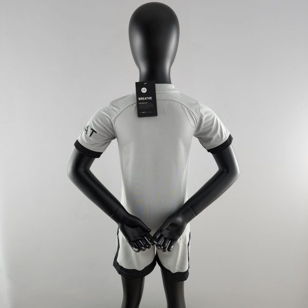 Back view of a black mannequin wearing a light gray athletic shirt; neck tag reads 'BREATHE' with a small circular logo.