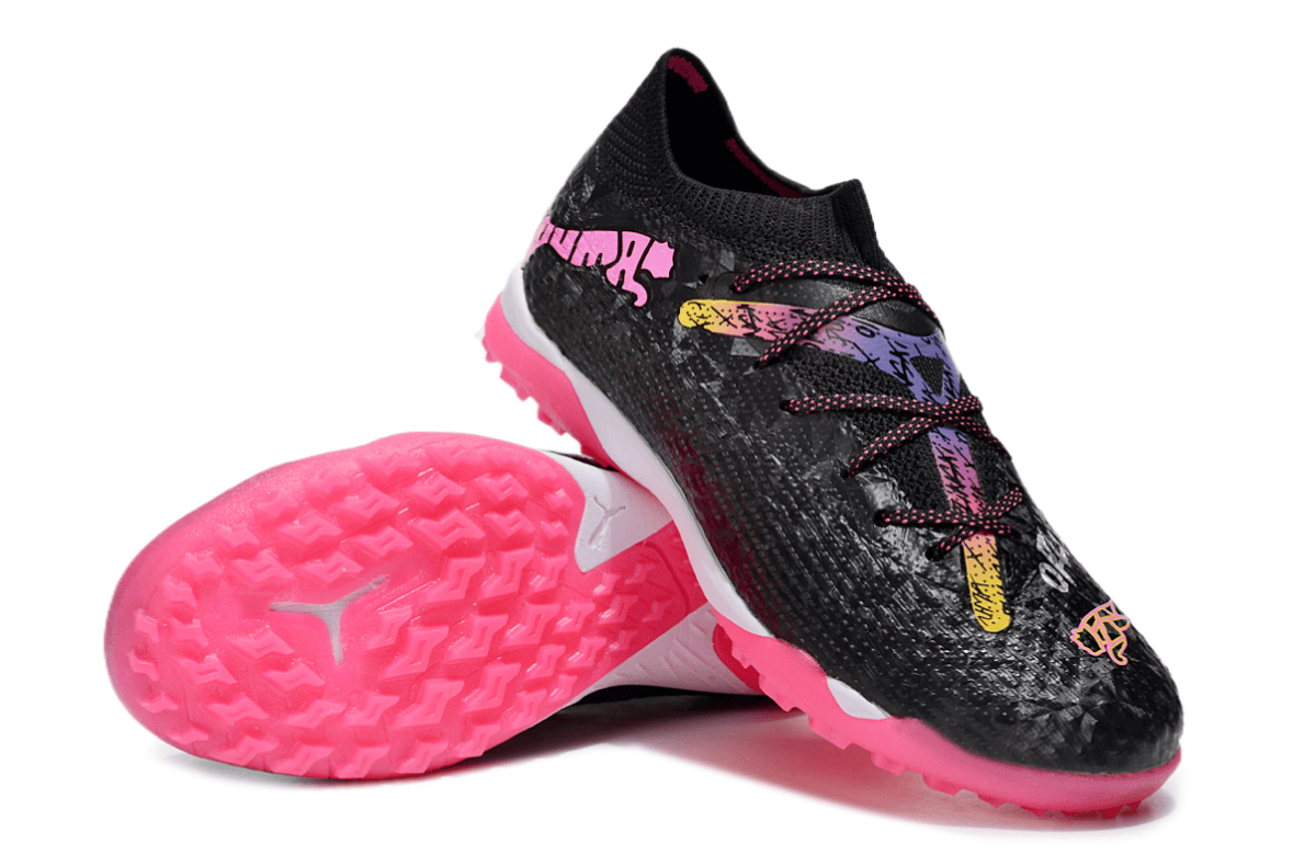 Pair of black athletic shoes with bright pink outsoles and multicolor laces, angled to show tread patterns on the bottom edge of the shoe.