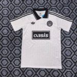 White Adidas soccer jersey with black collar and stripes, Oasis sponsor on chest, and club badge on the left chest.