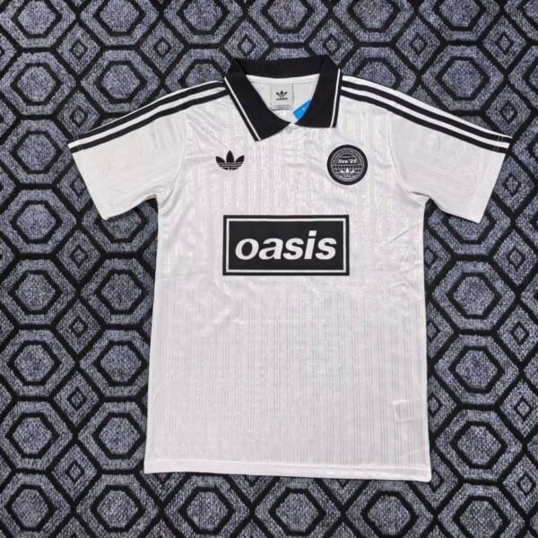 White Adidas soccer jersey with black collar and stripes, Oasis sponsor on chest, and club badge on the left chest.