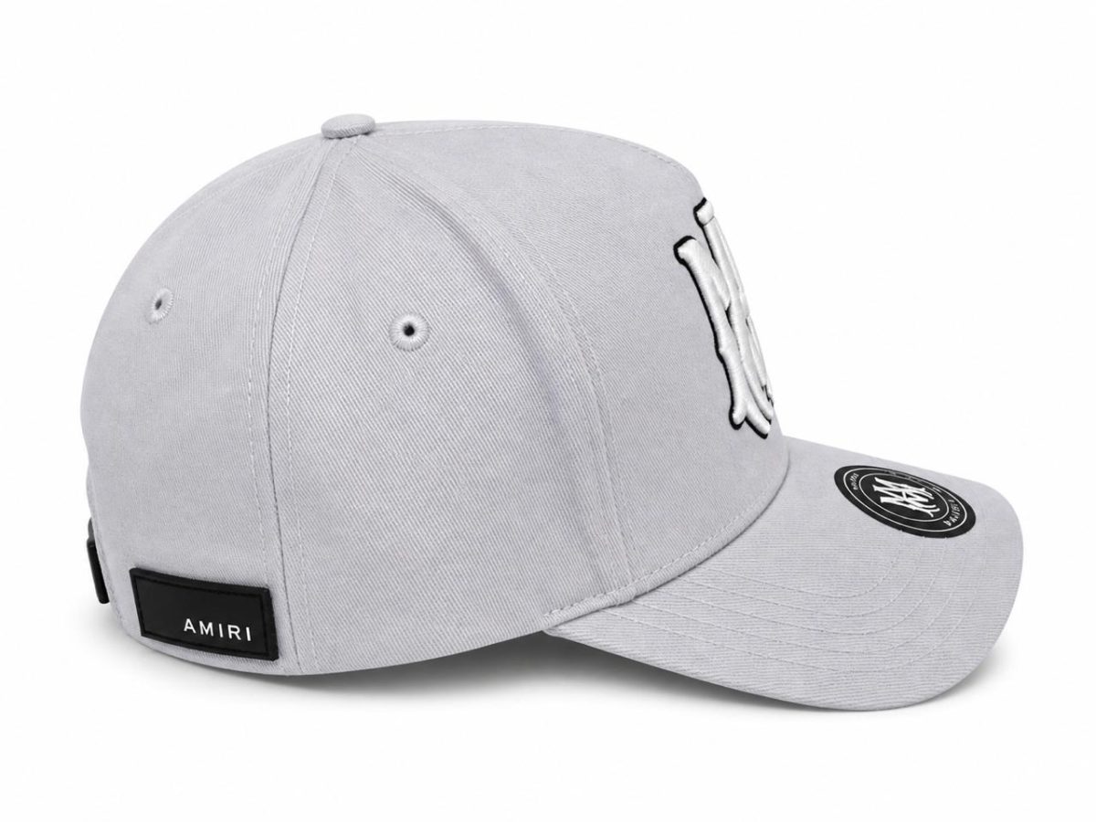 Light gray baseball cap with an Amiri brand patch on the back and embroidered logo on the front panel.