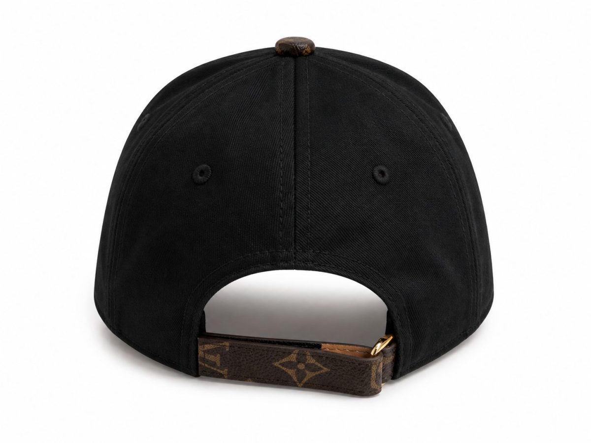 Back view of a black baseball cap with an LV-pattern adjustable strap and gold buckle