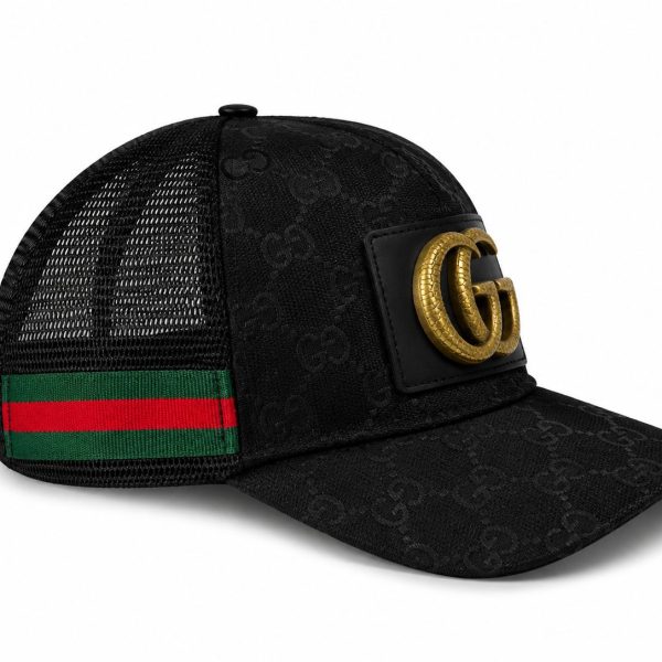 Black Gucci trucker cap with a gold double-G emblem on a leather patch and a green-red web strap at the back.