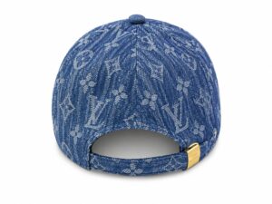 Back view of a blue denim cap with Louis Vuitton monogram pattern and an adjustable strap with a gold buckle.