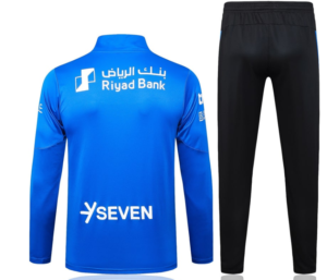 Back view of a blue long-sleeve athletic jersey with Riyad Bank and Seven logos paired with black track pants.