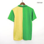 Color-block polo shirt hanging on a wooden hanger, with yellow on the left and green on the right from back view.