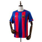 FC Barcelona home soccer jersey on a mannequin, blue and red vertical stripes with Nike logo and club crest on the chest.
