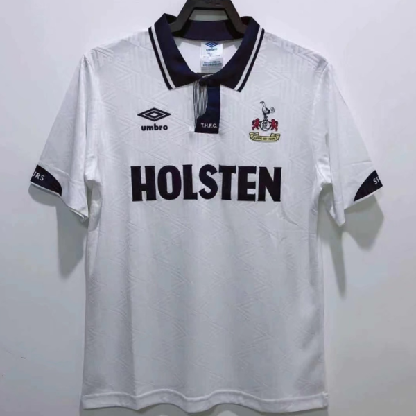 White Tottenham Hotspur football jersey on a hanger, with a dark collar and HOLSTEN across the chest