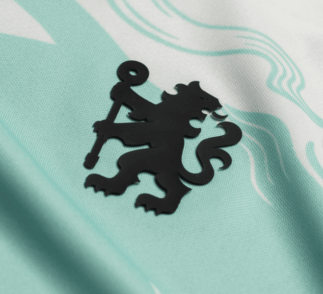 11_4d1b6938-330d-4b61-9133-34ece2112915 | UAE SPORT STORE Black silhouette of a lion standing on its hind legs, gripping a tall staff with a looped top, placed on light turquoise fabric.