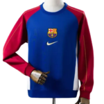 11_ccf7d8f2-4369-4617-a8b5-1de92e0ccbac | UAE SPORT STORE Blue Barcelona FC training jersey on a mannequin, featuring red sleeves, white side panels, and the club crest with a Nike swoosh.