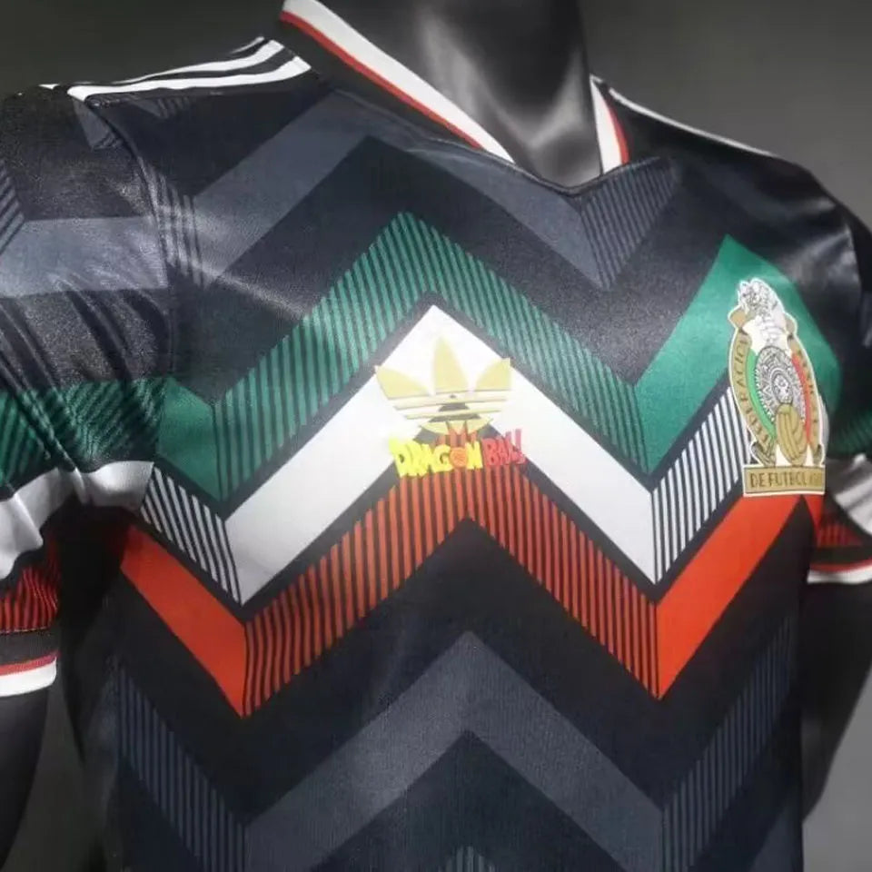 131af1d0aefd0505 | UAE SPORT STORE Close-up of a black sports jersey with multicolored chevron patterns and two patches on the chest.