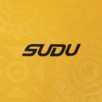 Close-up of yellow fabric with bold black letters spelling 'SODU' printed on it