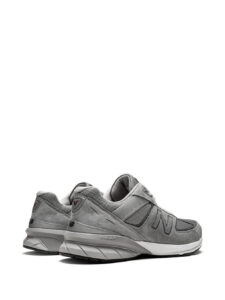 14105633_33201807_1000_83655f05-dead-472e-ae8e-11a6f0617d82 | UAE SPORT STORE Rear three-quarter view of a gray New Balance sneaker with suede and mesh panels and a chunky white midsole.