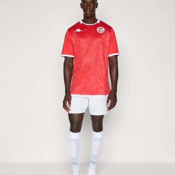 Male model wearing a red sports jersey with white trim, white shorts, and white socks, standing against a light background; crest on chest and Kappa logo visible.