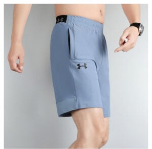 142aaebc | UAE SPORT STORE Light blue men's athletic shorts with Under Armour logo on the thigh and a side pocket.