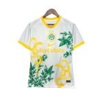 Palmeiras soccer jersey on a wooden hanger, white with yellow collar and tropical print leaves and snakes against a white background.