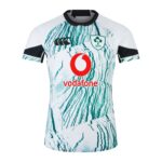 Front view of a white rugby jersey with teal tree-bark pattern, Vodafone logo in red, and IRFU crest on the chest.