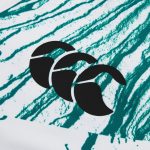 14763322-9545176592617311 | UAE SPORT STORE Close-up of teal brush-stroke pattern on white fabric with a partial black curved logo.