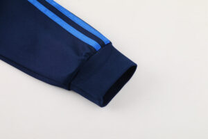 14ecb4cb | UAE SPORT STORE Navy blue track jacket sleeve with light blue side stripes and a ribbed cuff.