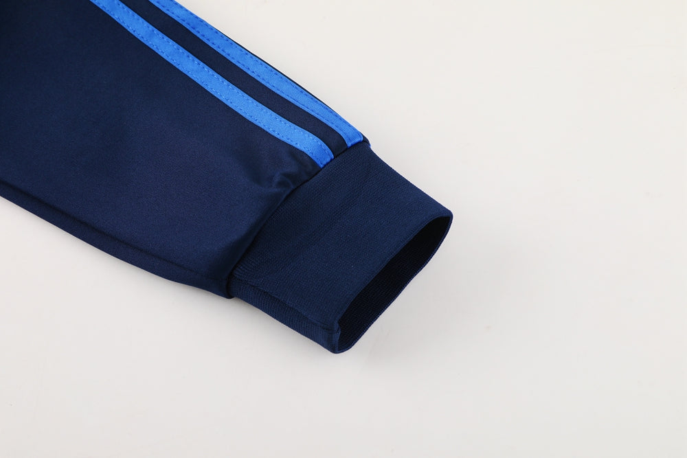 14ecb4cb | UAE SPORT STORE Navy blue track jacket sleeve with light blue side stripes and a ribbed cuff.