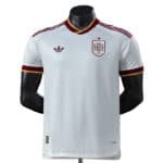 White Spain national team football jersey with crest on the left chest, Adidas logo on the right, and red-gold trim.