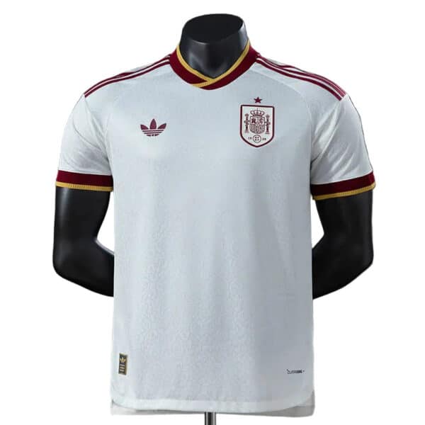 White Spain national team football jersey with crest on the left chest, Adidas logo on the right, and red-gold trim.