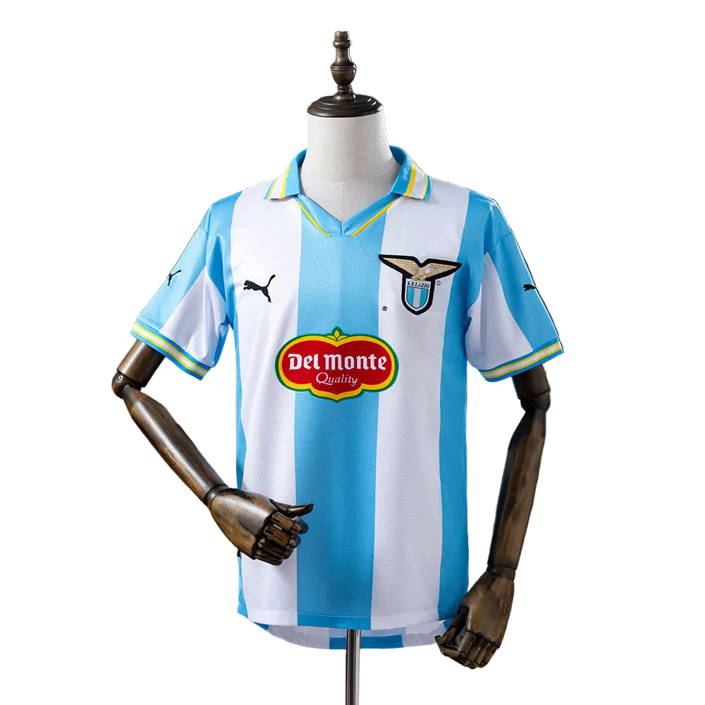 1596d5df Lazio soccer jersey on a mannequin with blue and white vertical stripes, Del Monte sponsor badge and club crest.