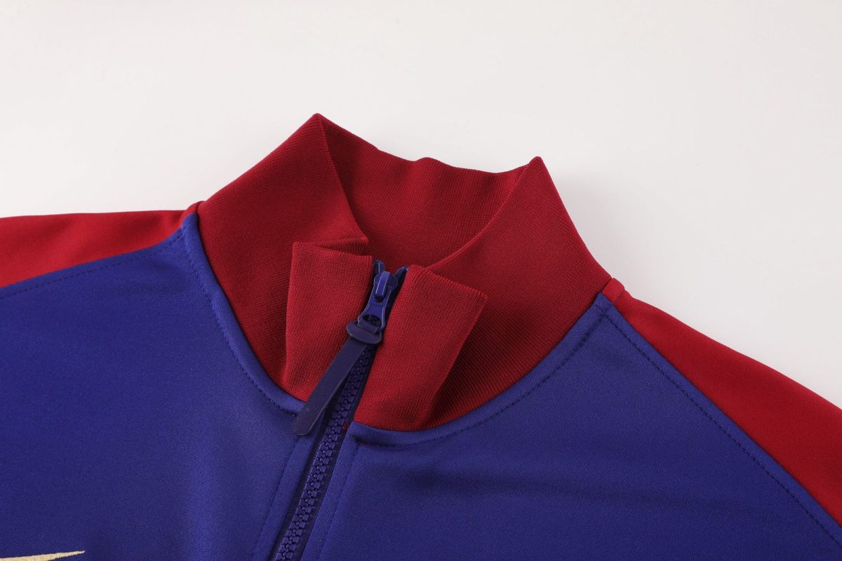 Close-up of a blue zipper on a blue and red jacket collar.