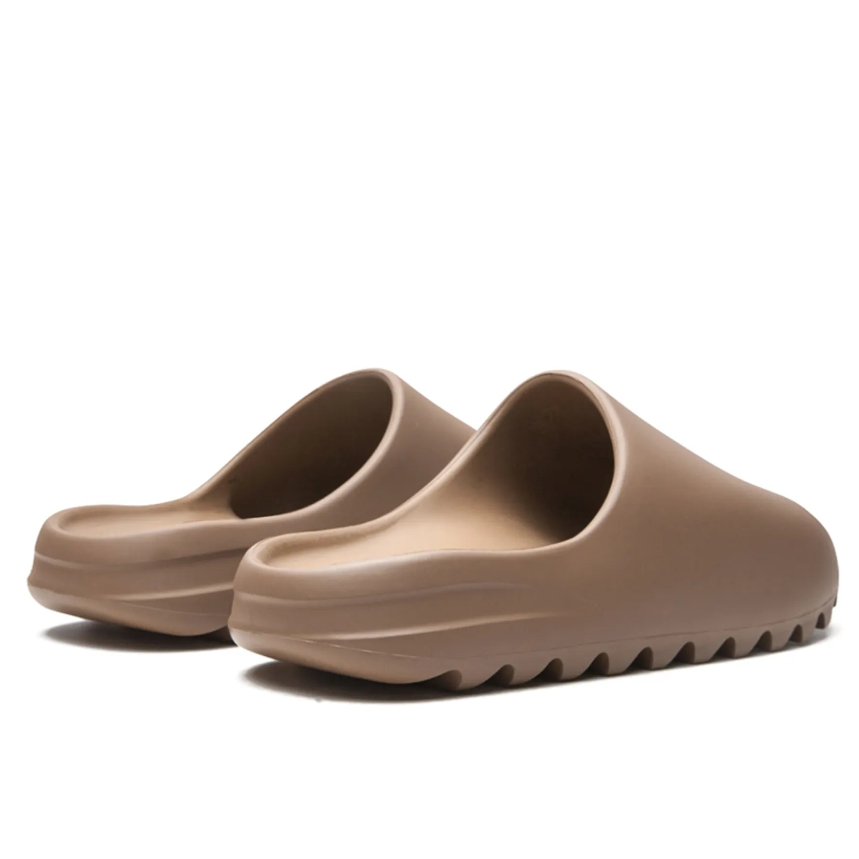 16791902_33127074_2048 Pair of taupe slide sandals with sculpted wavy uppers and thick ridged soles.