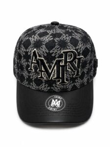 16982b76-78be-4aea-81a5-59097ae60172 | UAE SPORT STORE Black baseball cap featuring a gray graffiti pattern and a large embroidered AMIRI logo on the front; curved brim with an AMIRI sticker.